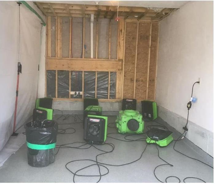 green equipment in garage to dry ceiling