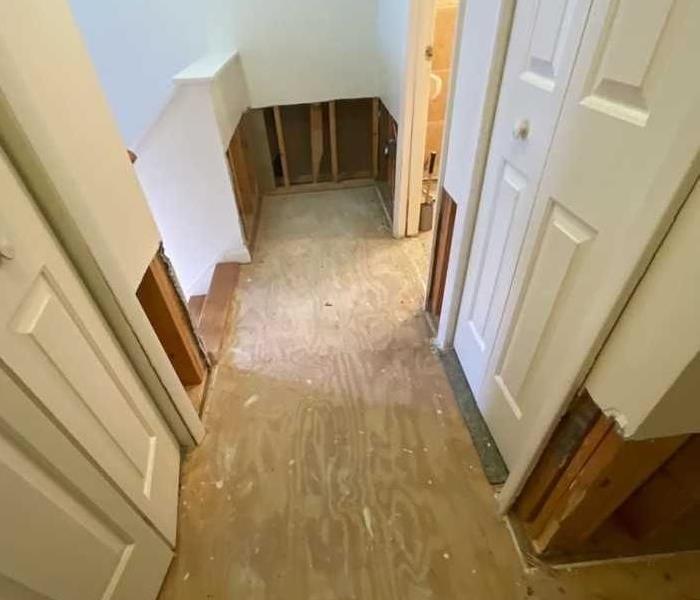 Clean, dry subfloor and lower wall studs in the upstairs hallway near the bathroom and stairs