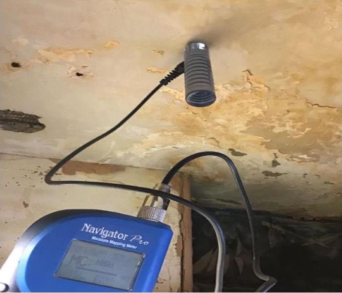 moisture reader detects high moisture in ceiling
