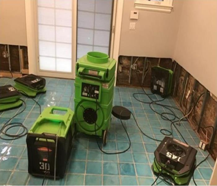 drying equipment in room with flood cut walls 